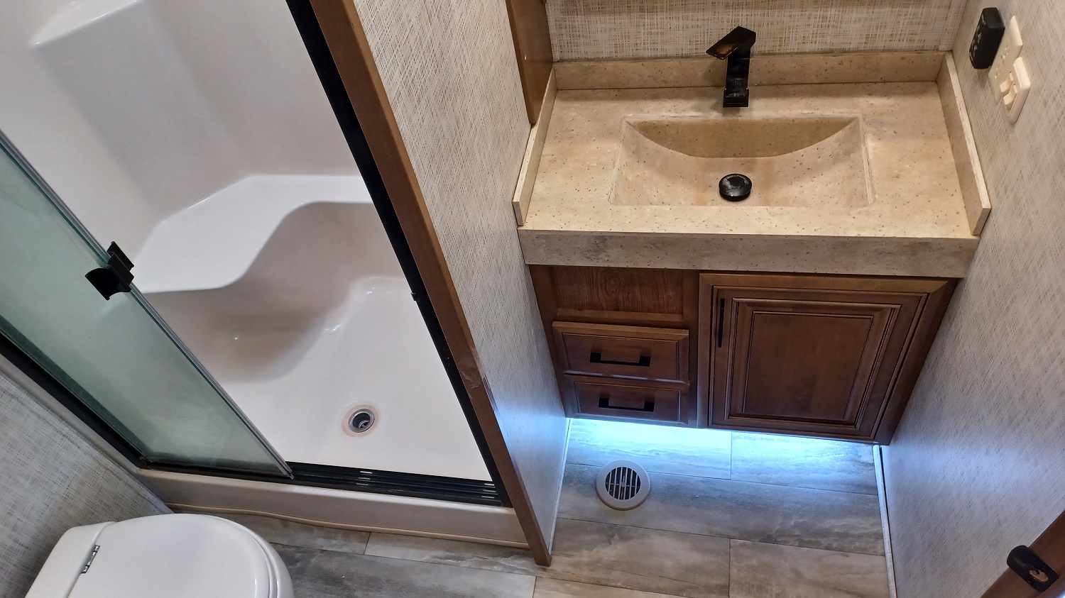 The bathroom with a shower seat